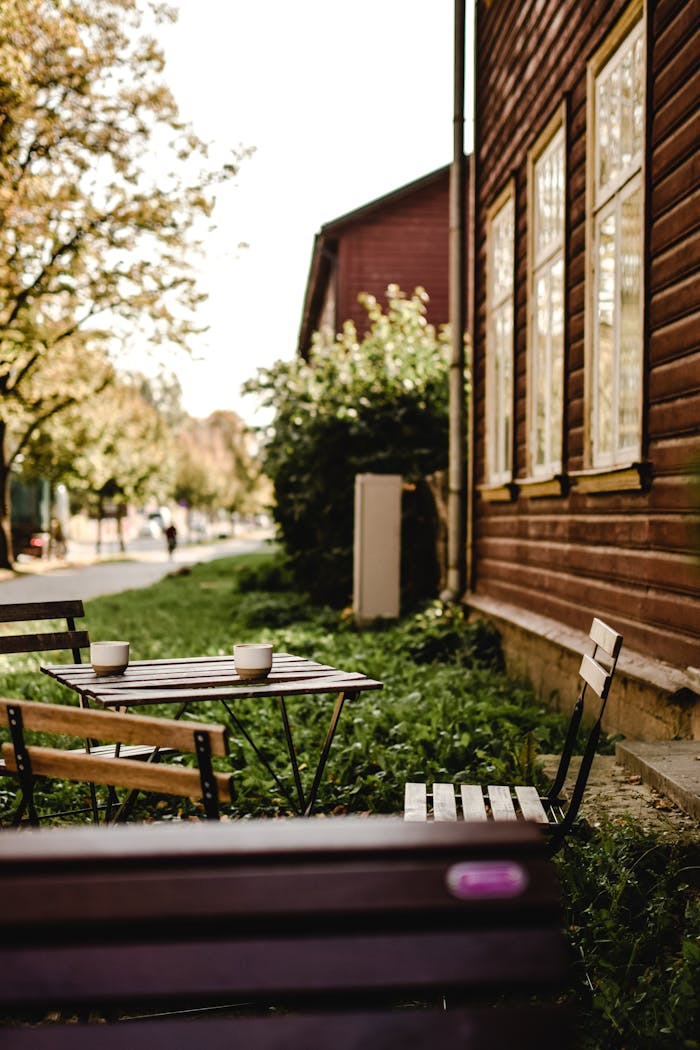 services-02 Charming wooden chairs and table outside a cafe in Tartu, Estonia, in autumn.